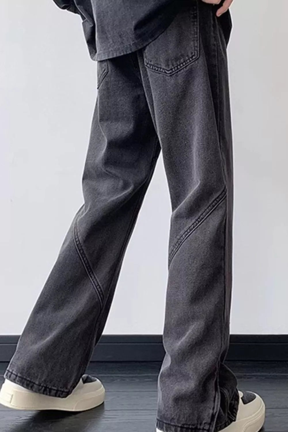 Black wide-leg stretch jeans with vintage wash and relaxed straight legs