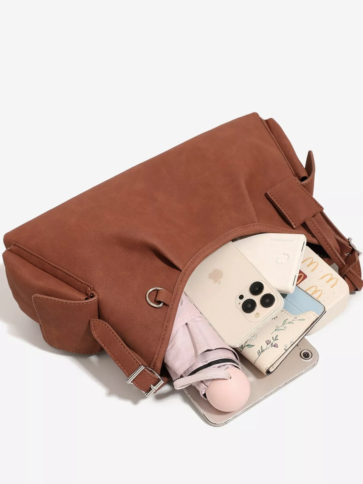 Brown suede bag with flap top and interior pocket; holds phone and cards