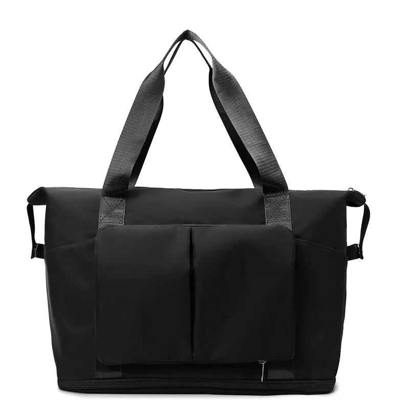 Black travel duffel bag with front organizer pocket, top handles, and side carry straps.