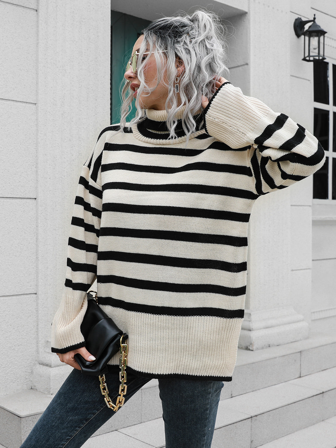 Black-and-white striped turtleneck sweater with drop shoulders and ribbed hem