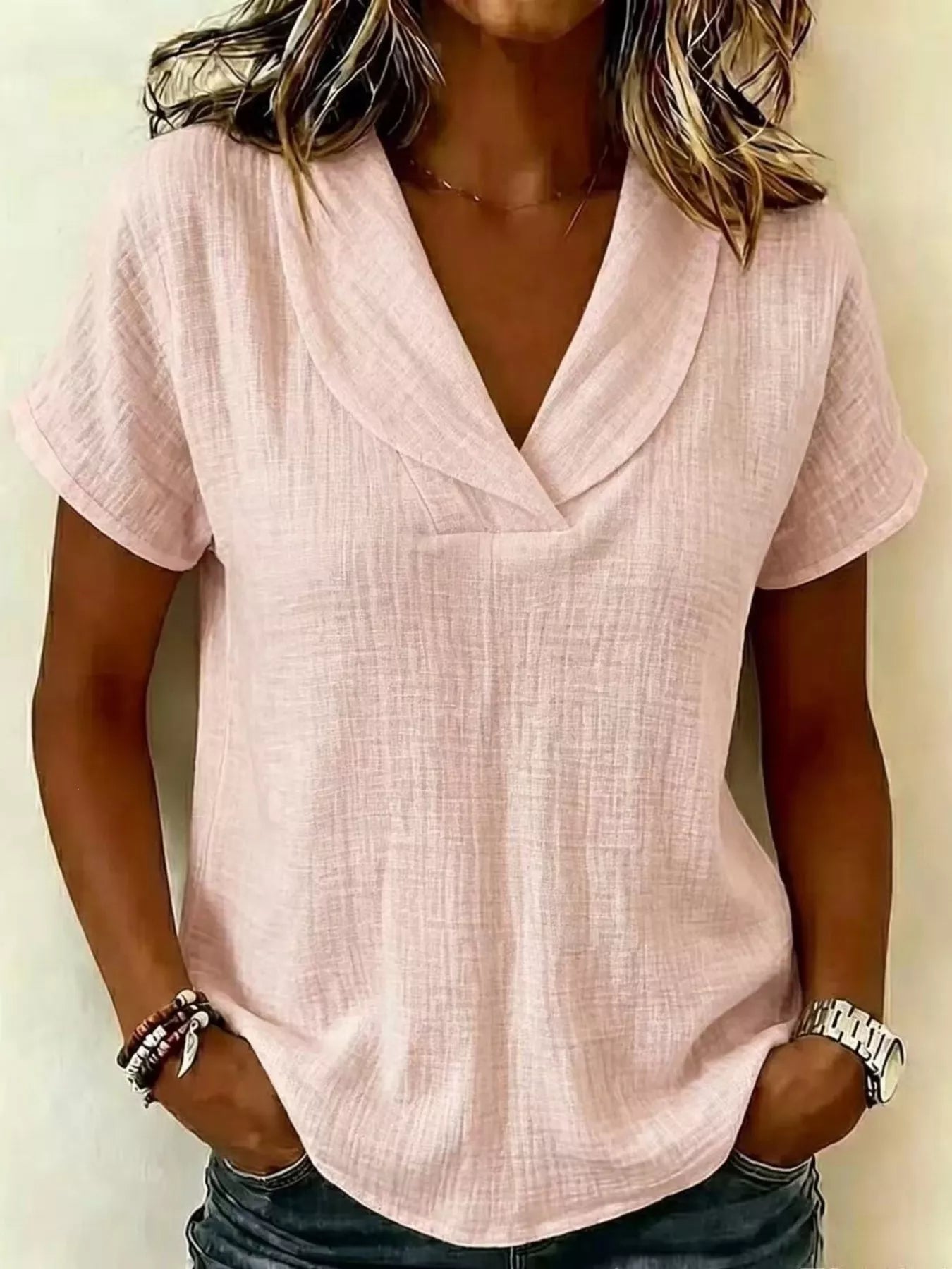 Light pink textured short-sleeve blouse with V-neck and draped front