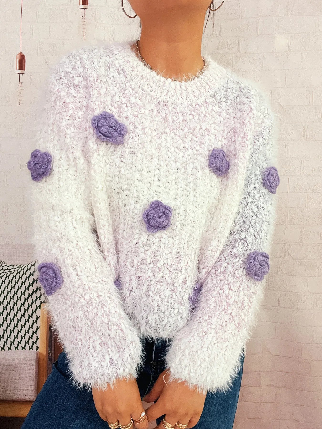 Flower-embellished round-neck sweater, fuzzy white knit with purple rosette embellishments