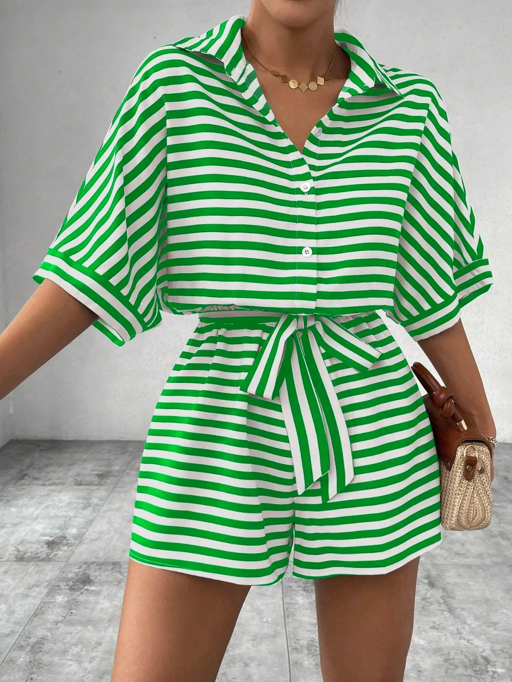 Green-and-white striped tie-waist romper with half-button V-neck and belted shorts