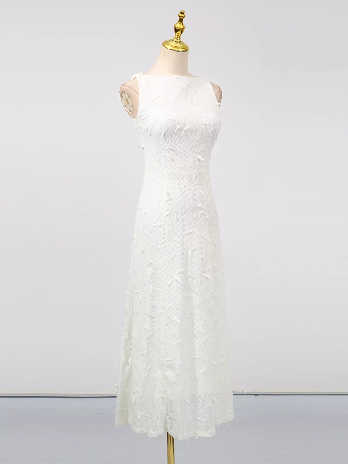 Cedar & Moore Sleeveless Floral Applique Midi Dress in white by Trendsi with textured leaf appliques