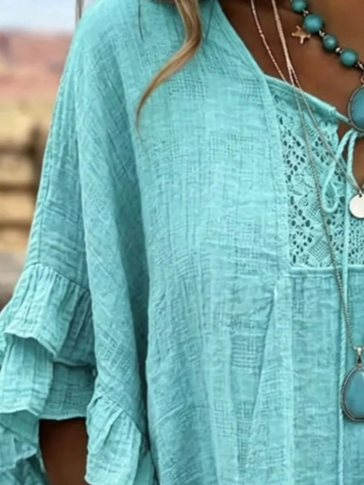 Turquoise tie-neck blouse with lace yoke and ruffled sleeve cuffs