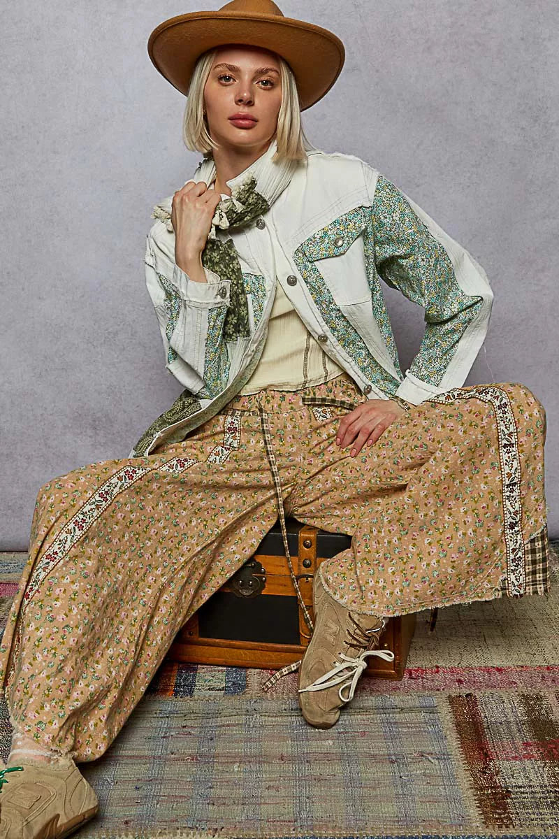 Off-white patchwork denim jacket with green floral panels, button front, long sleeves