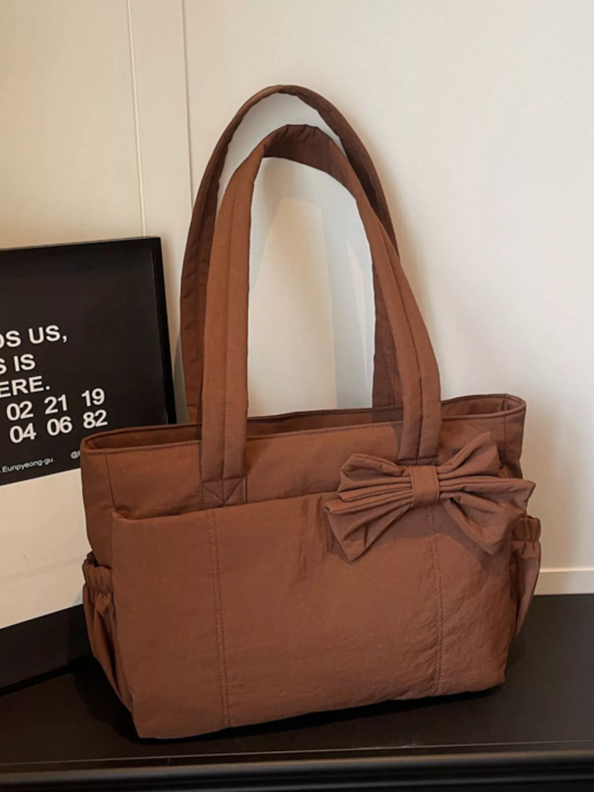 Brown medium casual tote bag with tied bow detail at the front