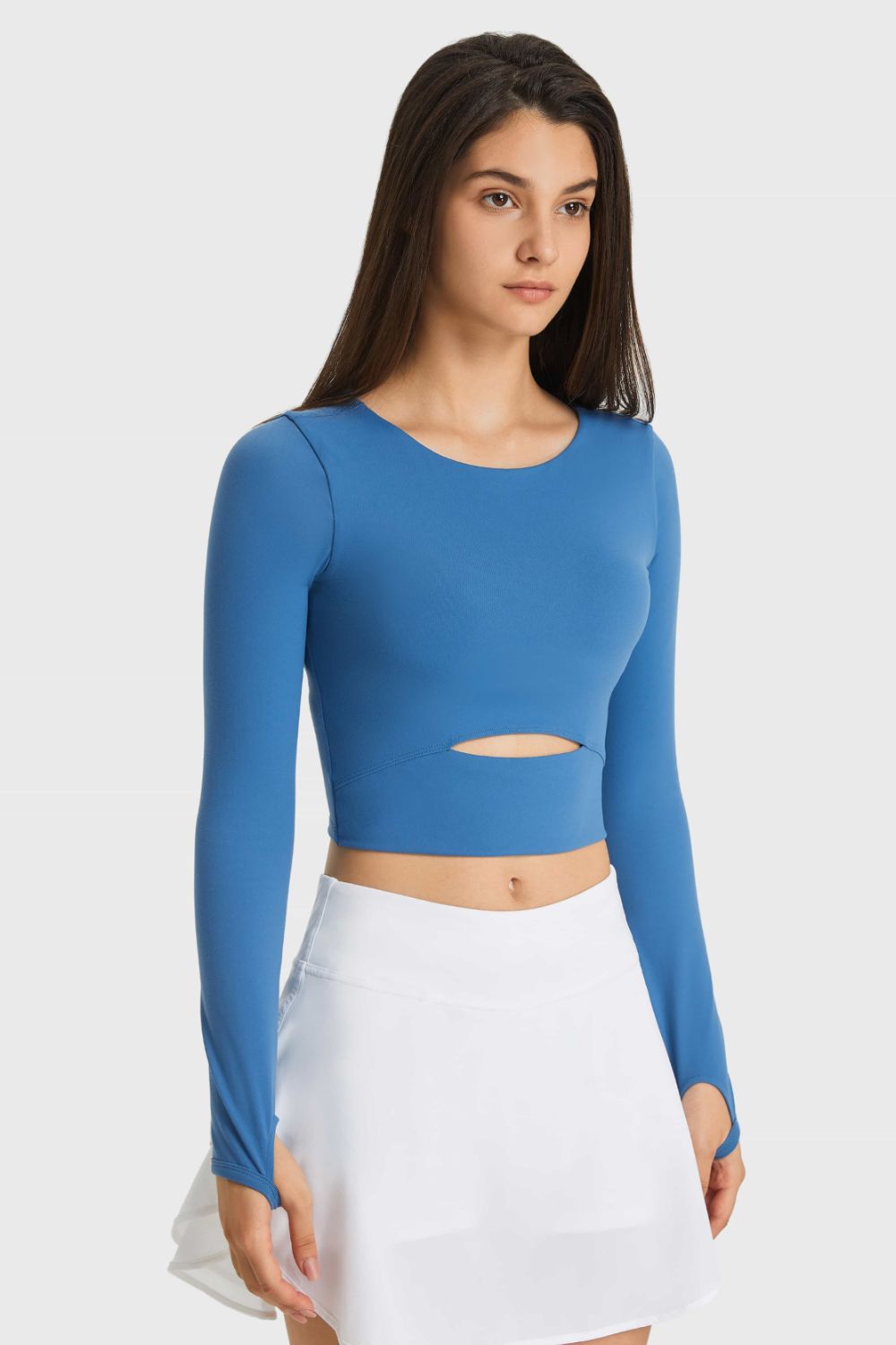 Blue long-sleeve cropped sports top with waist cutout, front view