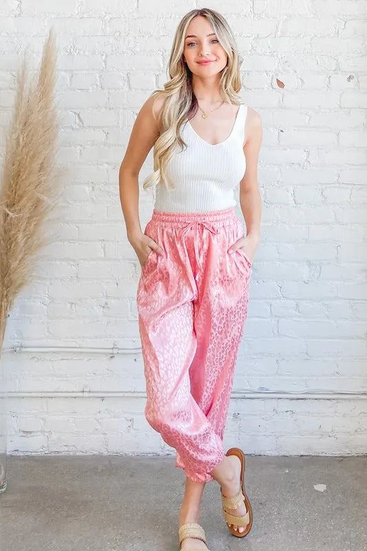 Pink satin leopard print joggers, front view with ruched elastic waistband