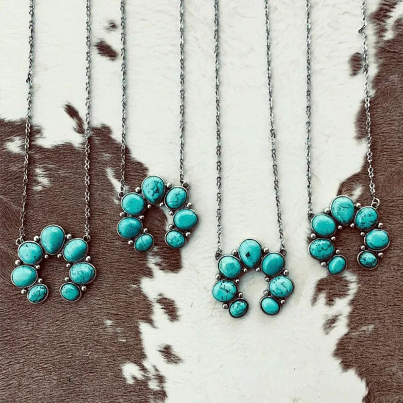 Turquoise oval pendant necklaces with silver-tone chains, flower-shaped stone clusters.
