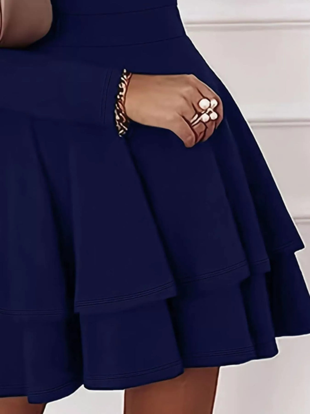 Navy tiered ruffle mini skirt detail with V-neck long sleeves