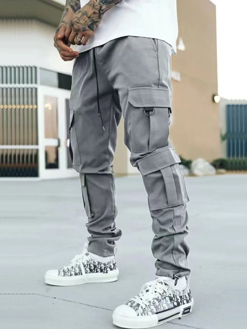 Men's gray drawstring cargo pants with flap pocket on the leg and cuffed ankles