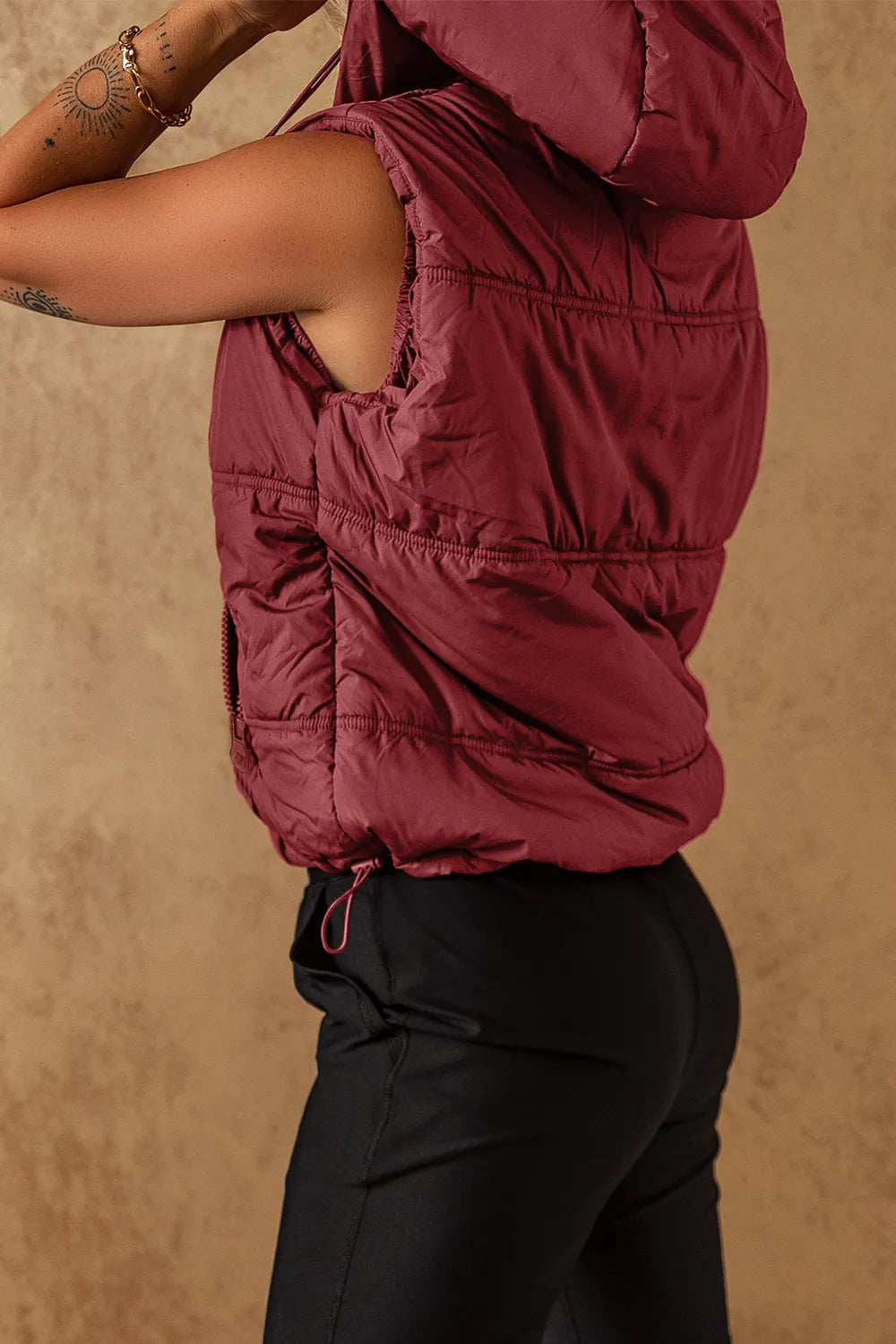 Burgundy hooded puffer vest coat with drawstring hem and quilted side panels