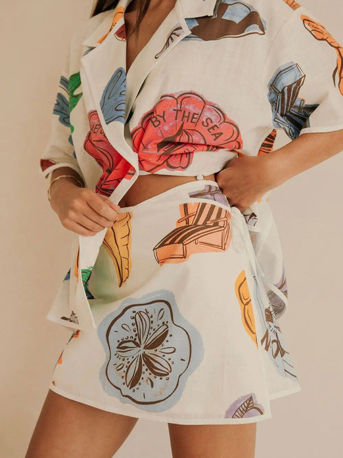 Women’s white button-up short-sleeve shirt with heart and shell graphic, matching shorts
