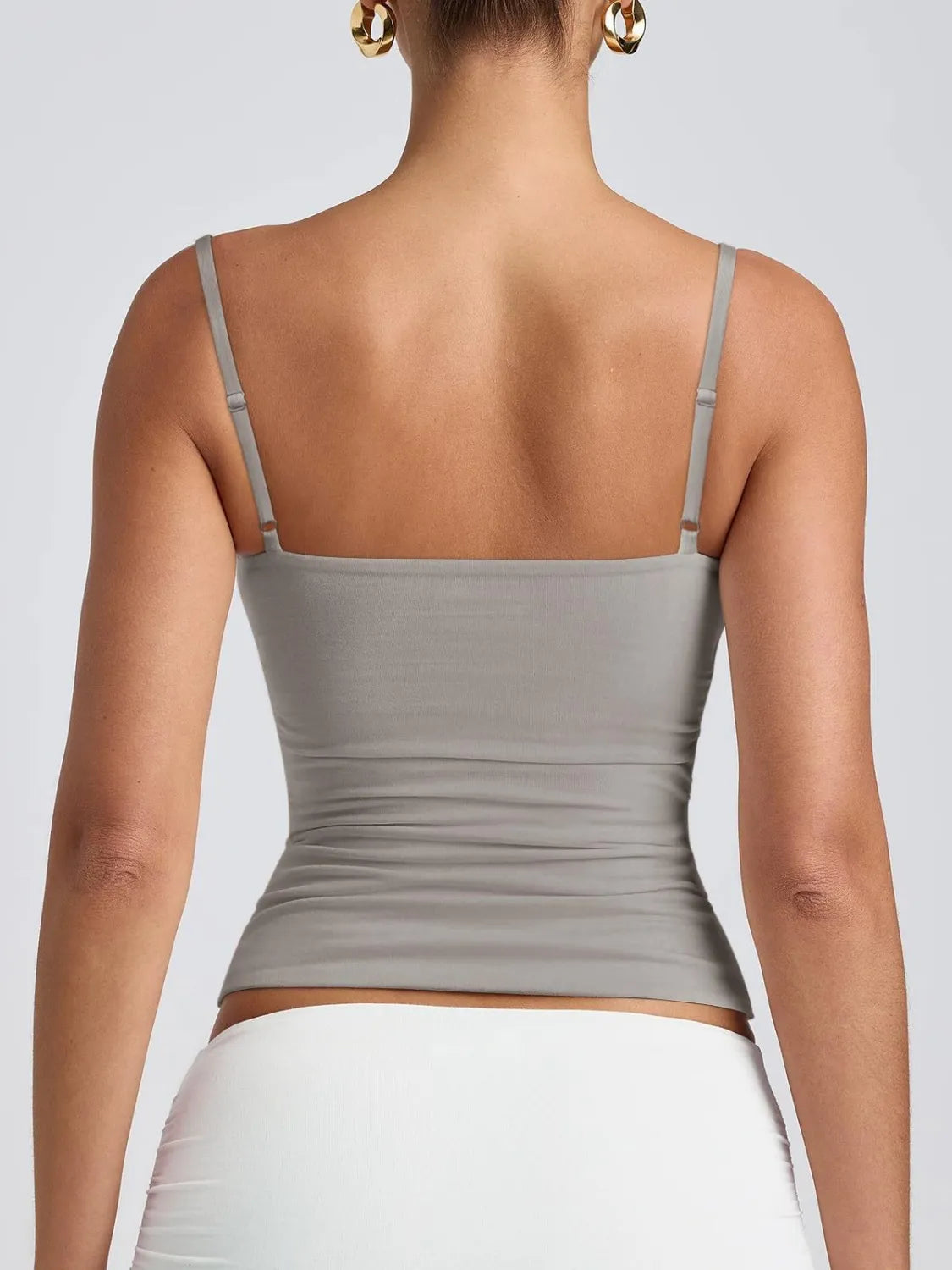 Scoop neck cami in light gray, adjustable spaghetti straps, ruched midsection.