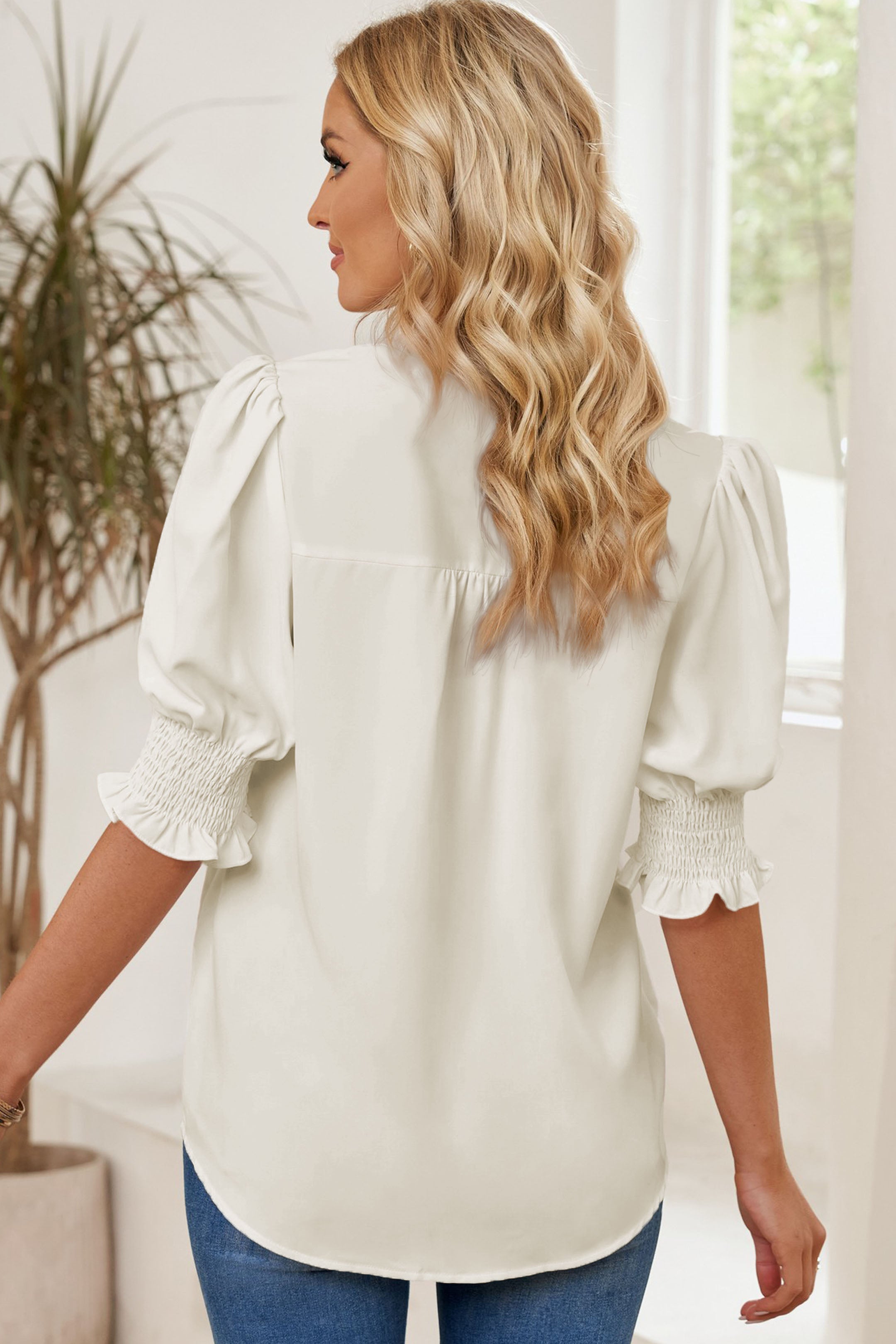 White smocked flounce sleeve blouse with notched neckline, three-quarter puff sleeves