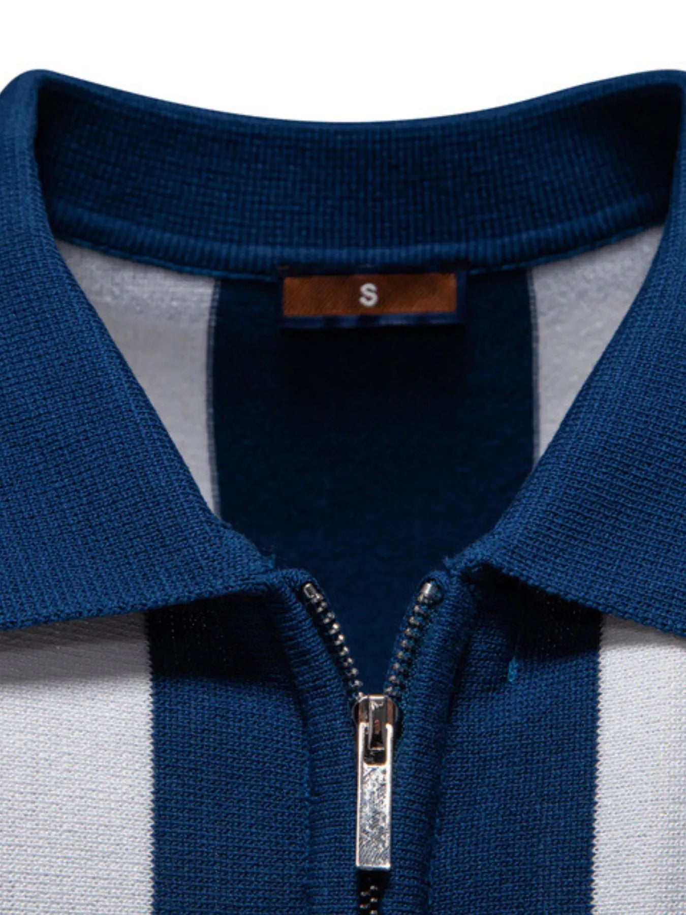 Zip-collar polo shirt close-up with blue knit collar and silver zipper on striped placket