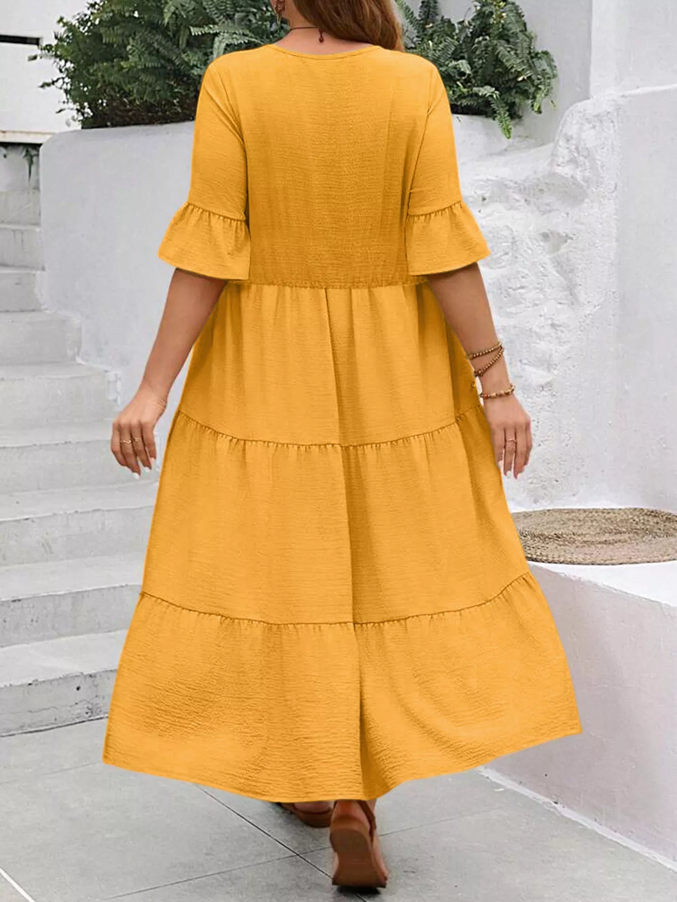 Back view tiered midi dress with bell ruffle sleeves, mustard yellow