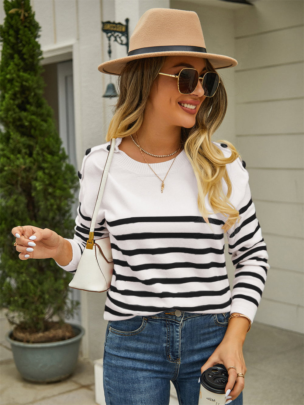 White striped pullover sweater with round neck and black shoulder button details