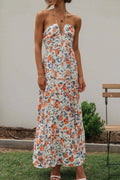 Floral halter neck tiered maxi dress in light blue with orange and green flower print.