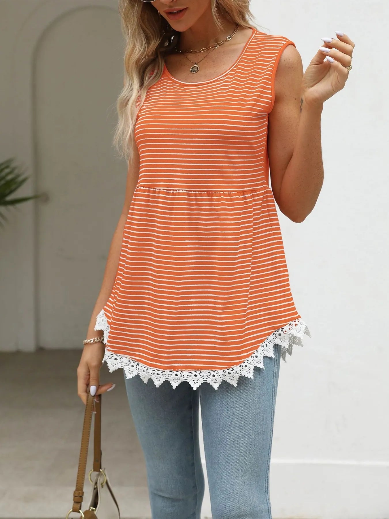 Orange striped sleeveless babydoll tank with lace-trim hem and rounded neckline