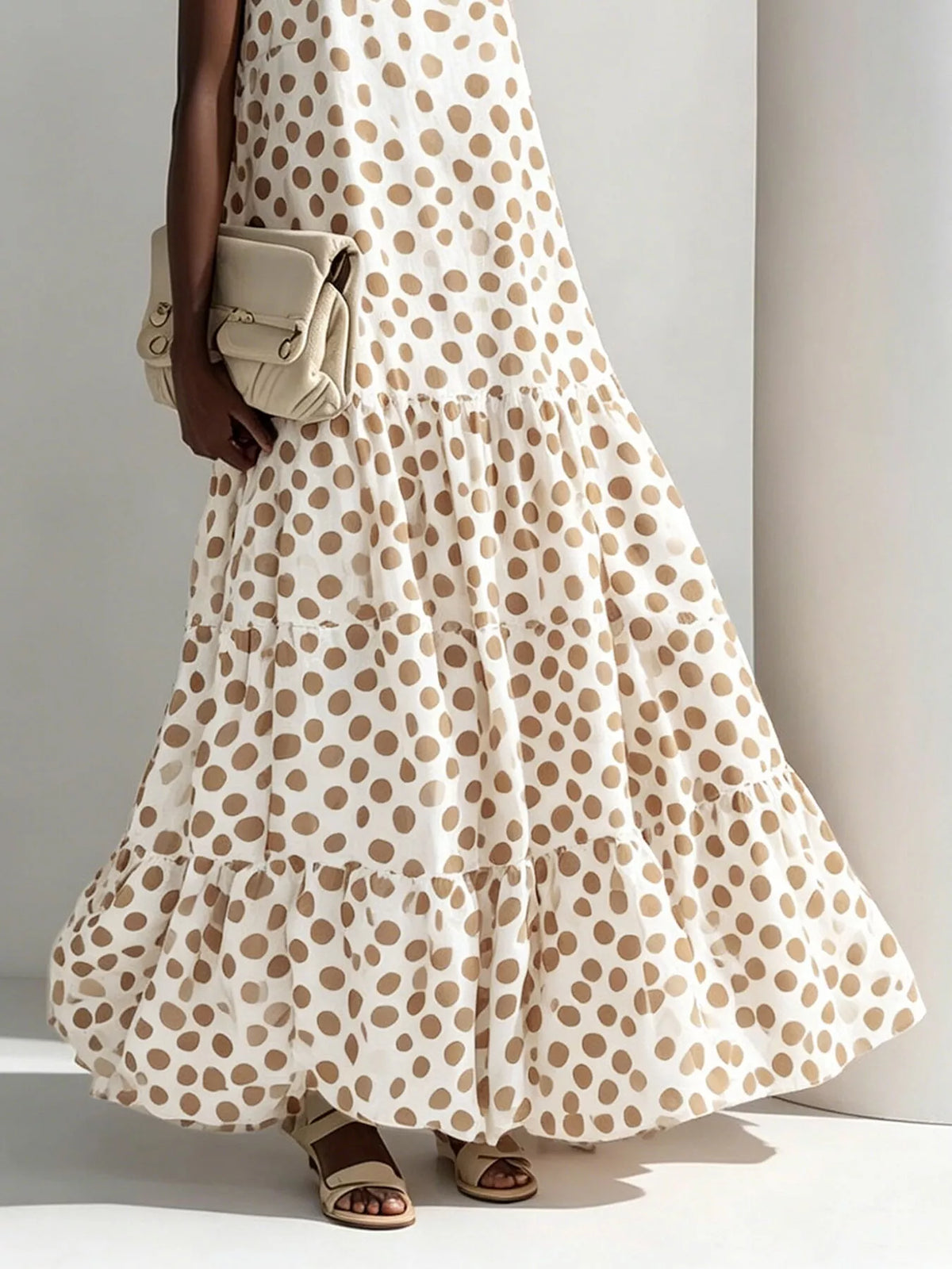 Beige sleeveless tiered maxi dress with polka dot pattern and tiered skirt
