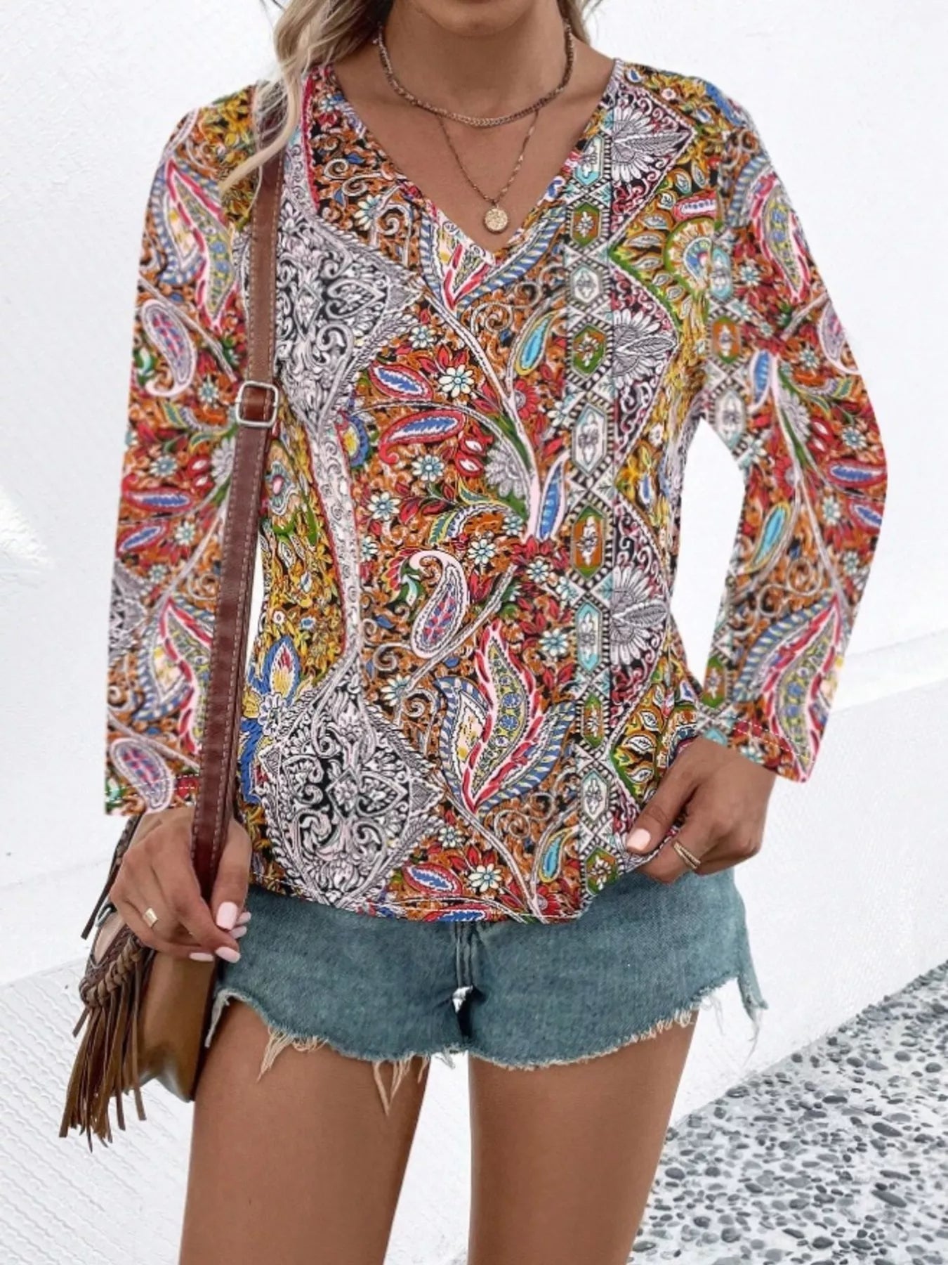Front view: multicolor paisley V-neck long-sleeve blouse with long flared sleeves