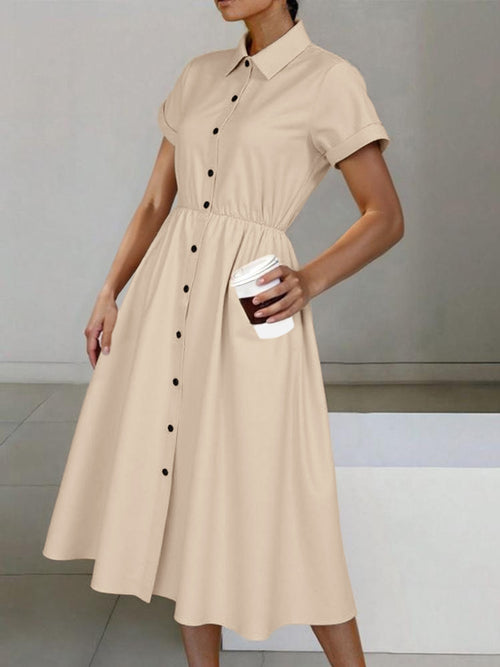 Beige button-down short-sleeve midi shirt dress with collar, black buttons, and gathered waist