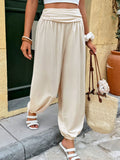 Cream high-waist joggers with ruched elastic waistband and ankle cuffs