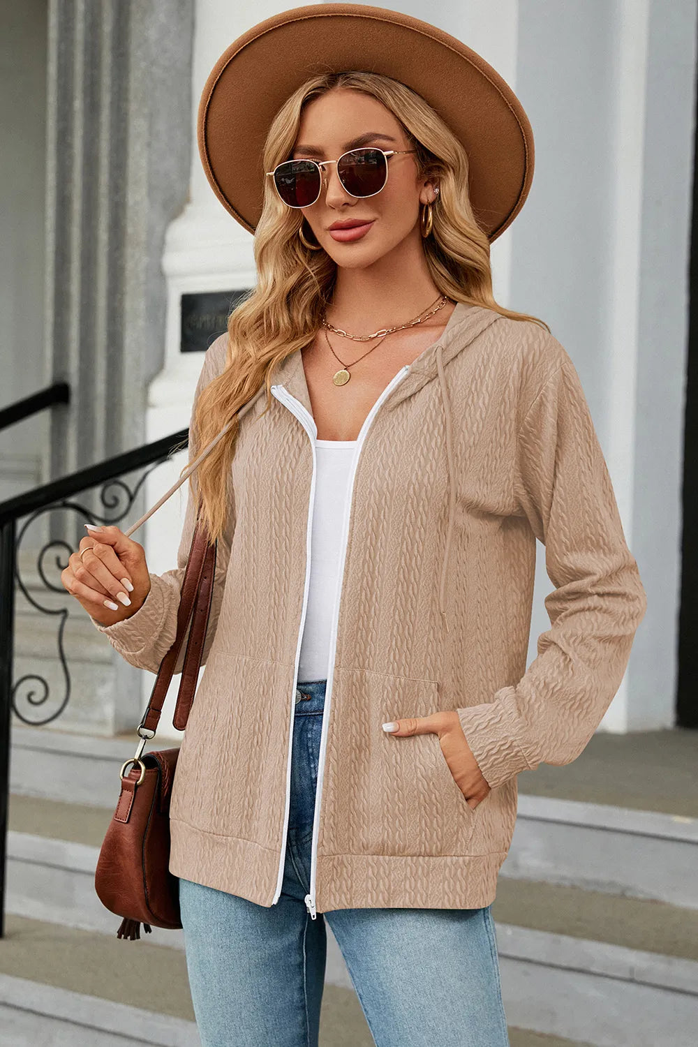 Cream zip-up hoodie with drawstring hood, long sleeves, and front pockets