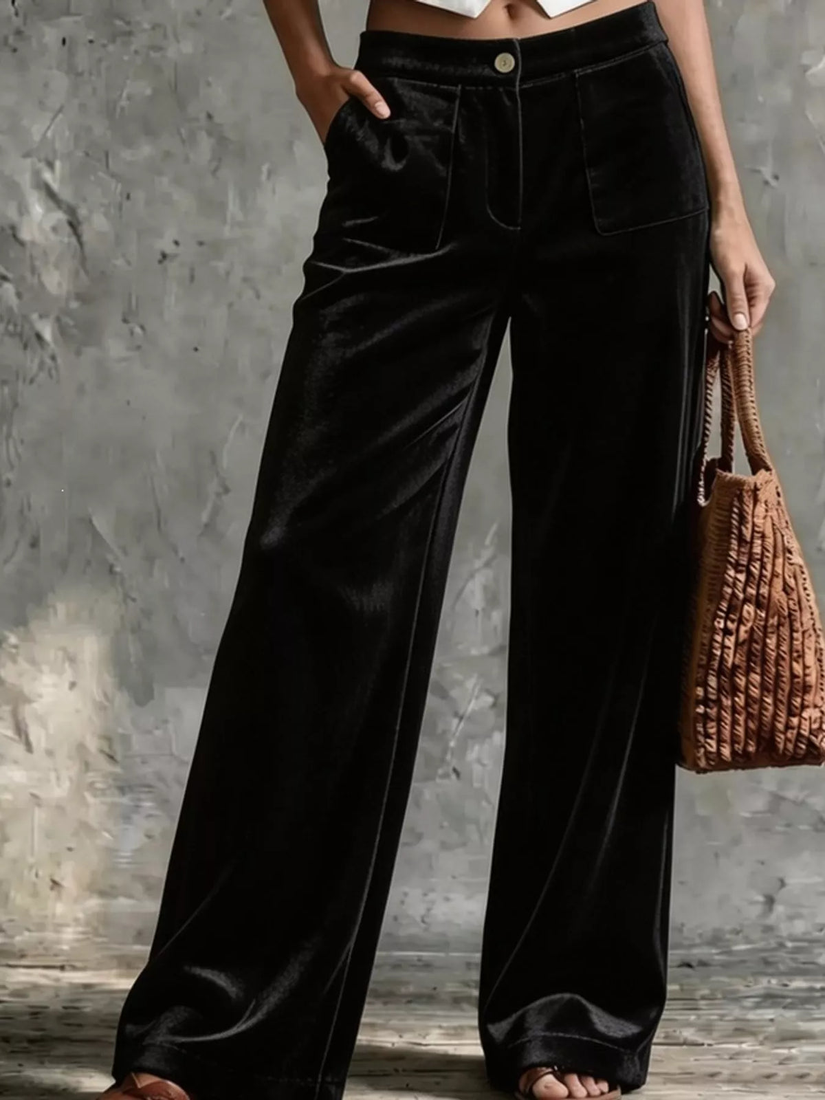 Black velvet wide-leg pants with high waist, button closure, and front pockets
