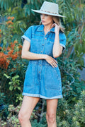 Light blue denim romper with elastic waist, button front, chest pockets, short sleeves