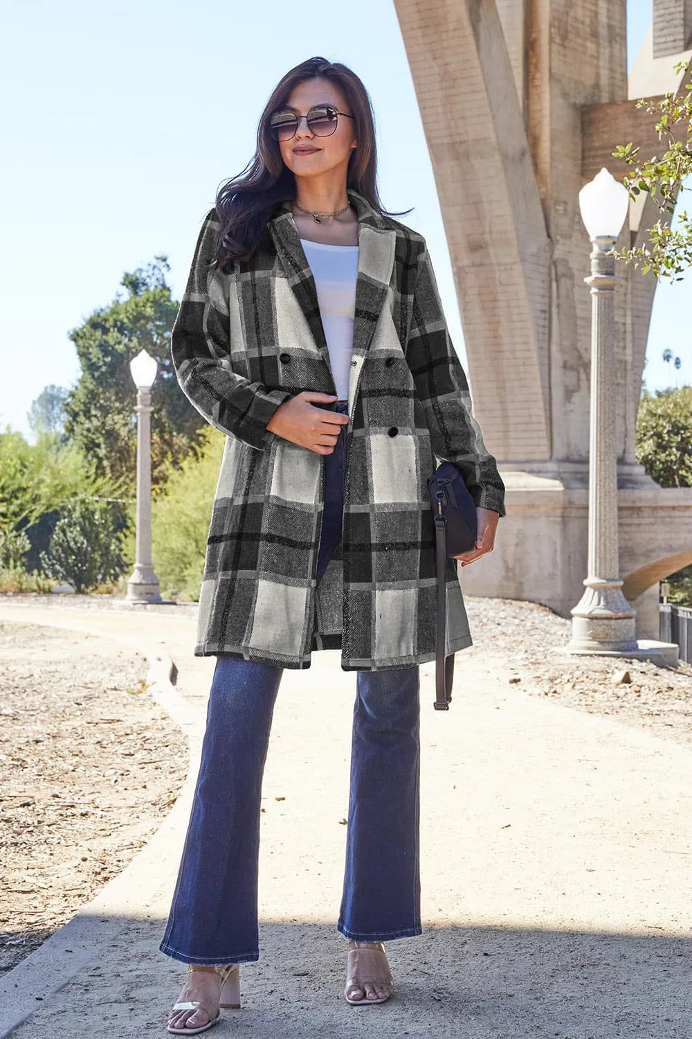Plaid button-up coat with lapel collar in black and white blocks with dark buttons