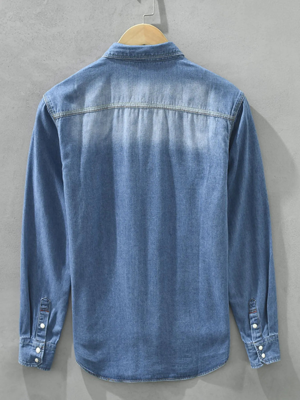 Men's washed denim button-up shirt back view with long sleeves, light blue