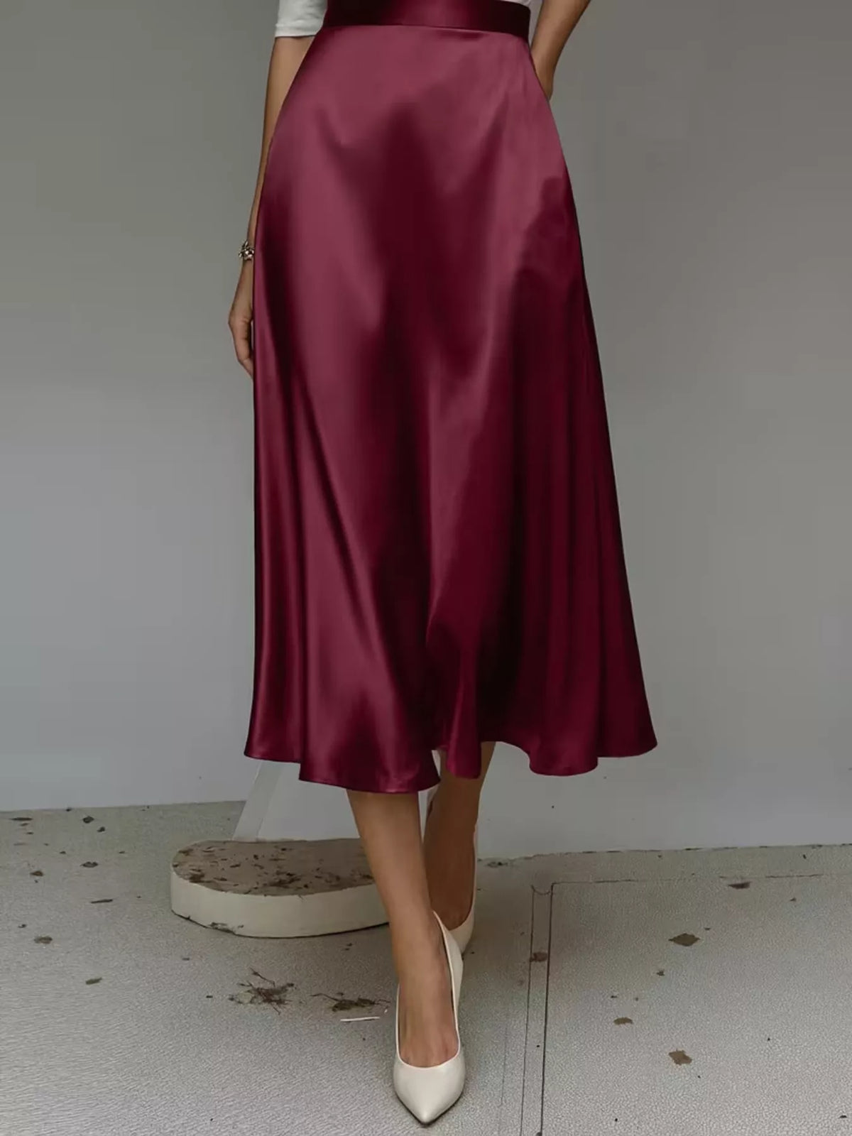 High-waist satin midi skirt in wine red, flared A-line cut with soft drape.