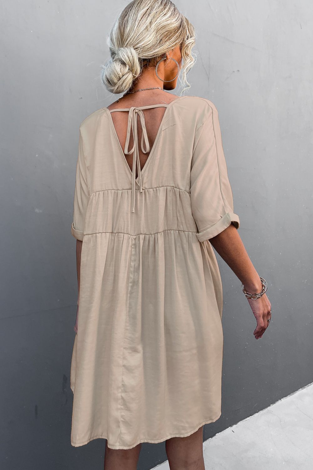 Apricot tiered mini dress with crisscross tie-back on the open back