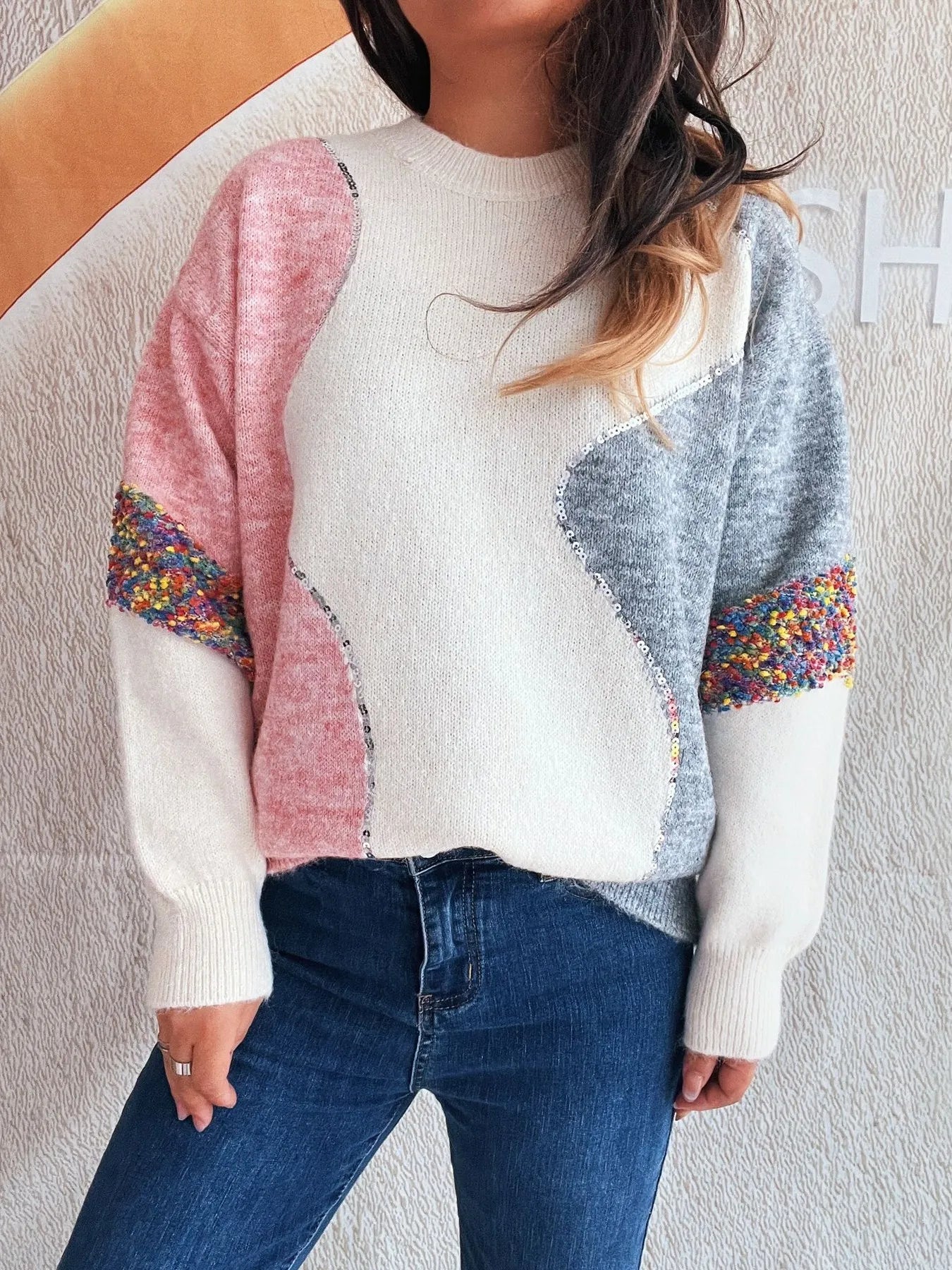 Dropped shoulder sweater with crew neck, white body, pink sleeve, blue side panel, cuffs