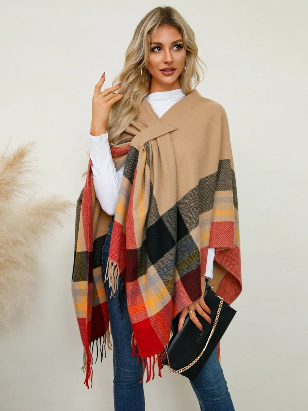 Plaid contrast fringe poncho draped over shoulders with multicolor check pattern