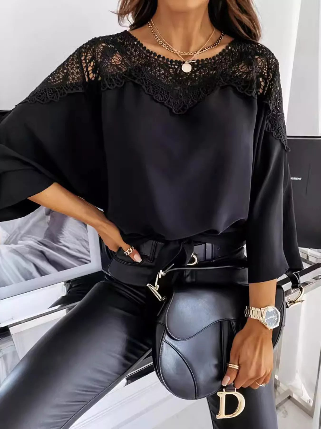 Black blouse with lace-trim shoulders and round neckline, satin-like sleeves