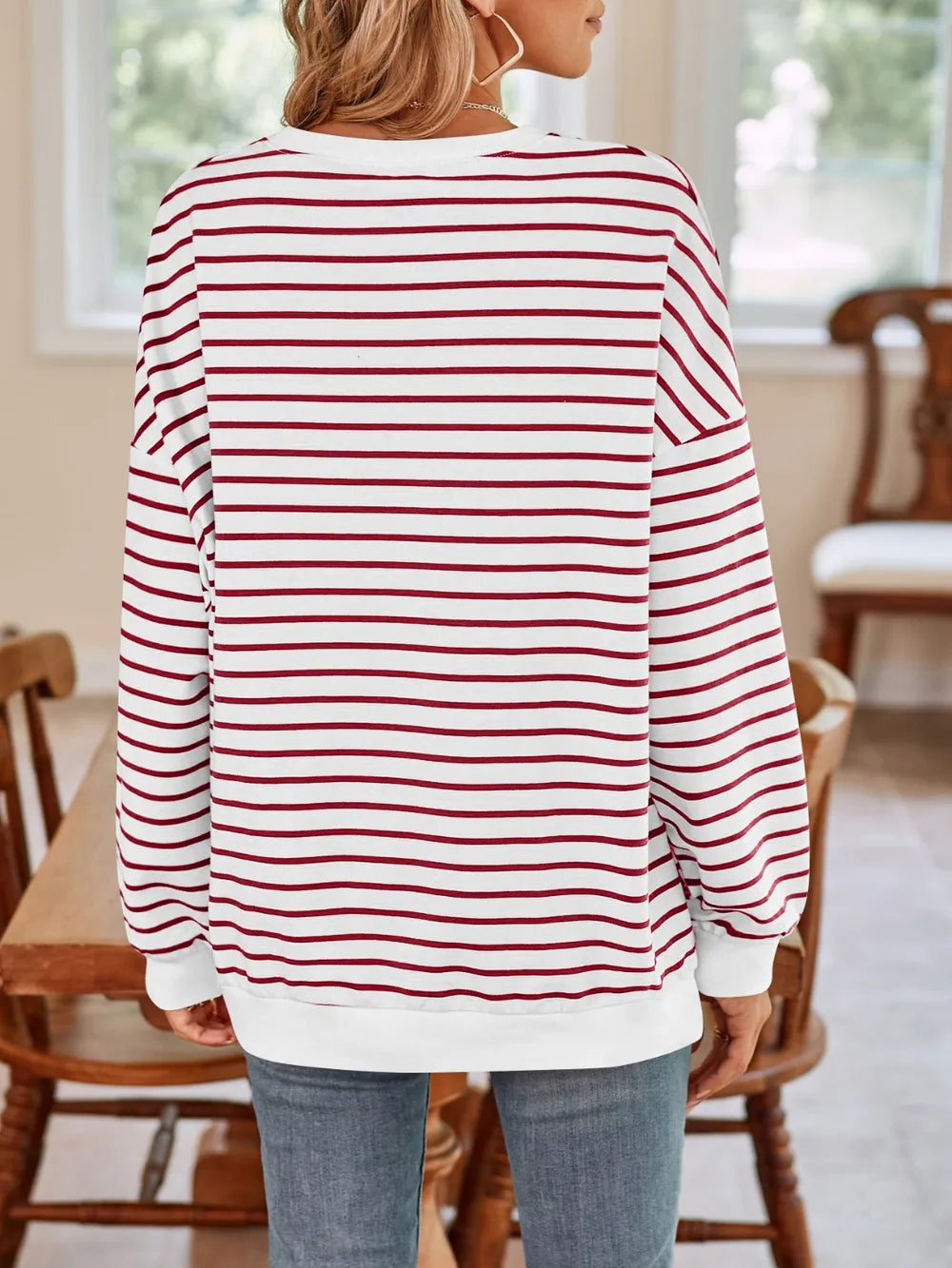 Back view of striped long-sleeve sweatshirt with round neck, red-and-white horizontal stripes