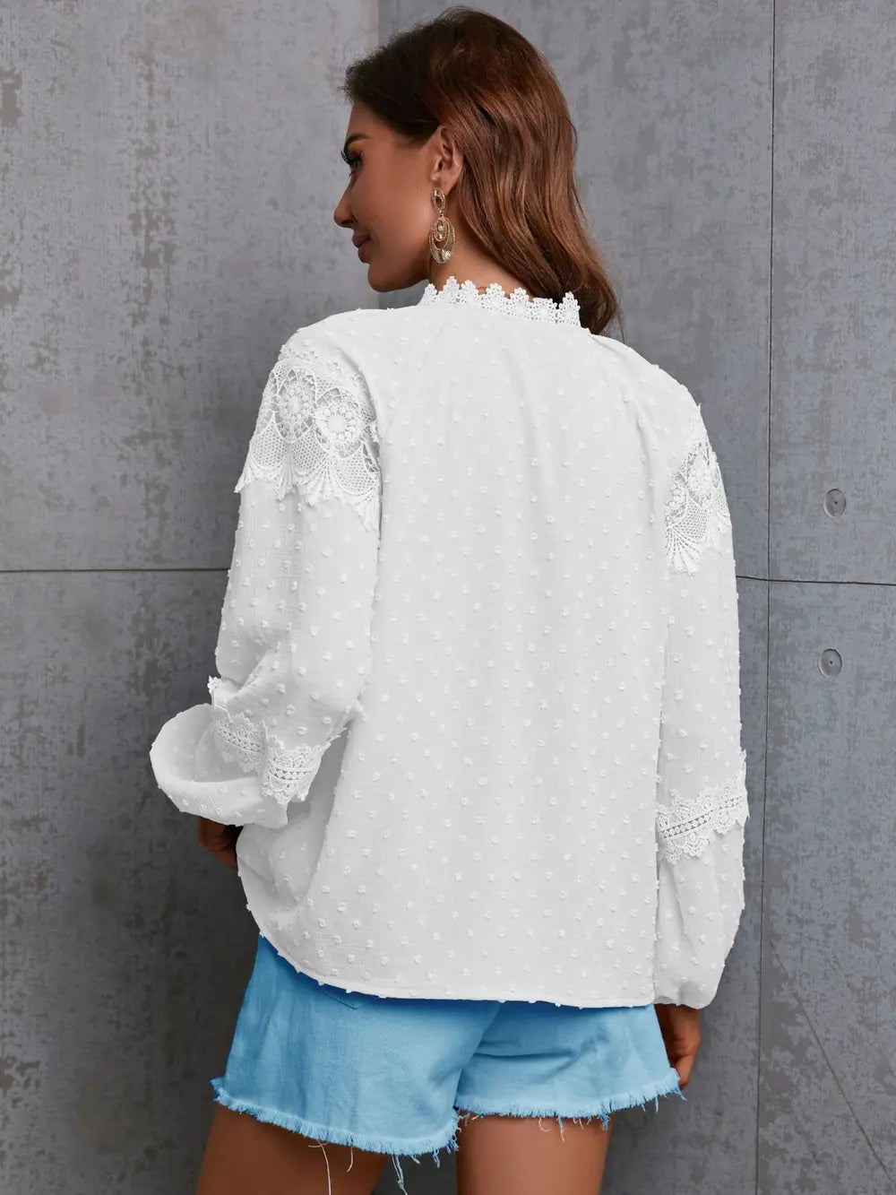 White crochet blouse back view with long sleeves and lace-like shoulders