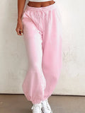 Pink drawstring sweatpants, tapered leg and elastic cuffs, side pockets