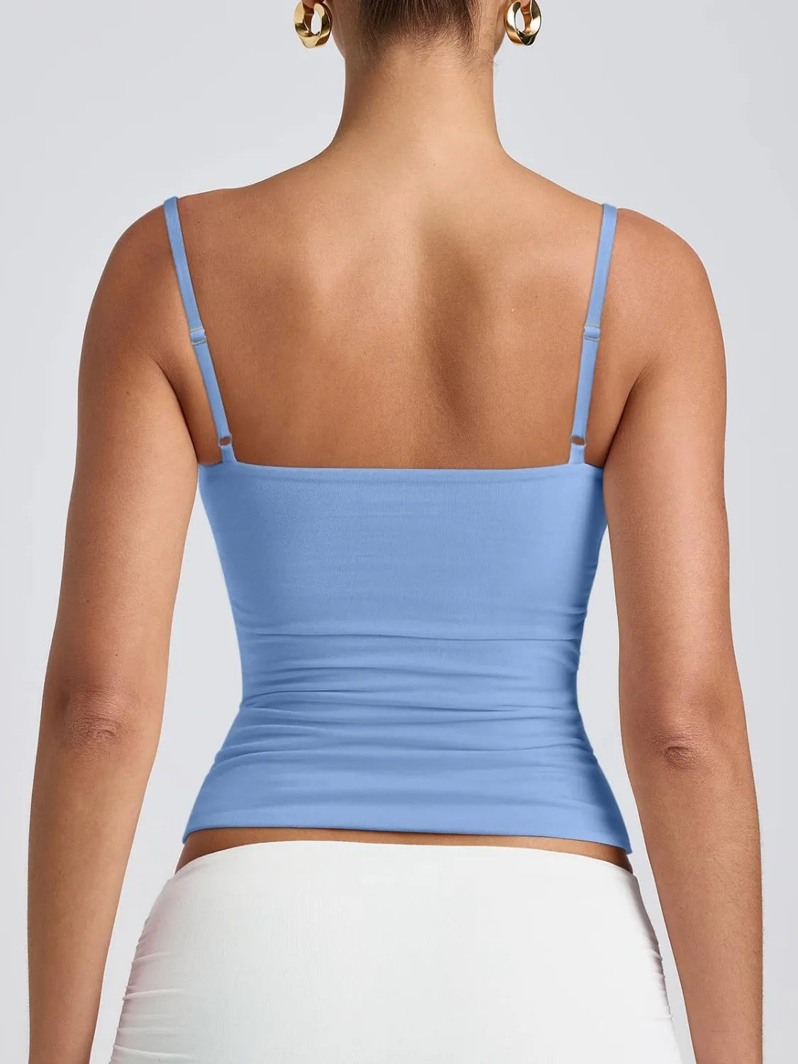 Scoop neck cami in light blue, visible back straps and smooth fitted ruched waist.