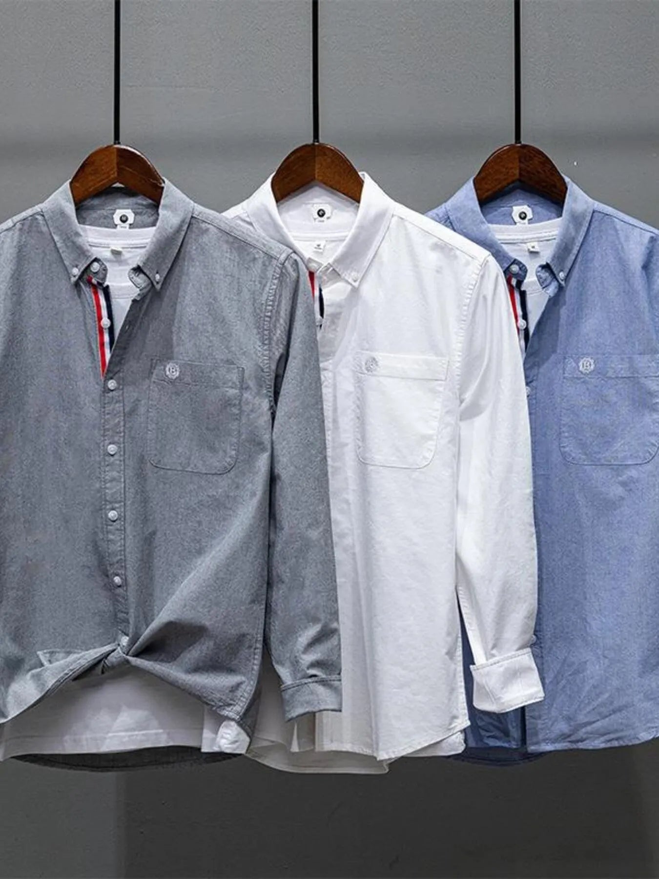 Pack of button-up long-sleeve shirts in grey, white, and sky blue