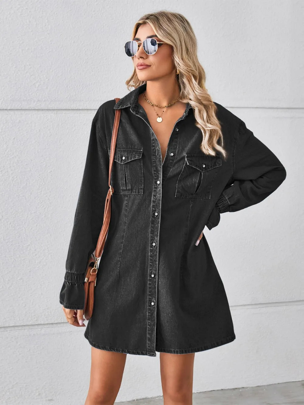 Black denim mini dress with chest pockets, button front, dropped shoulder style, long sleeves