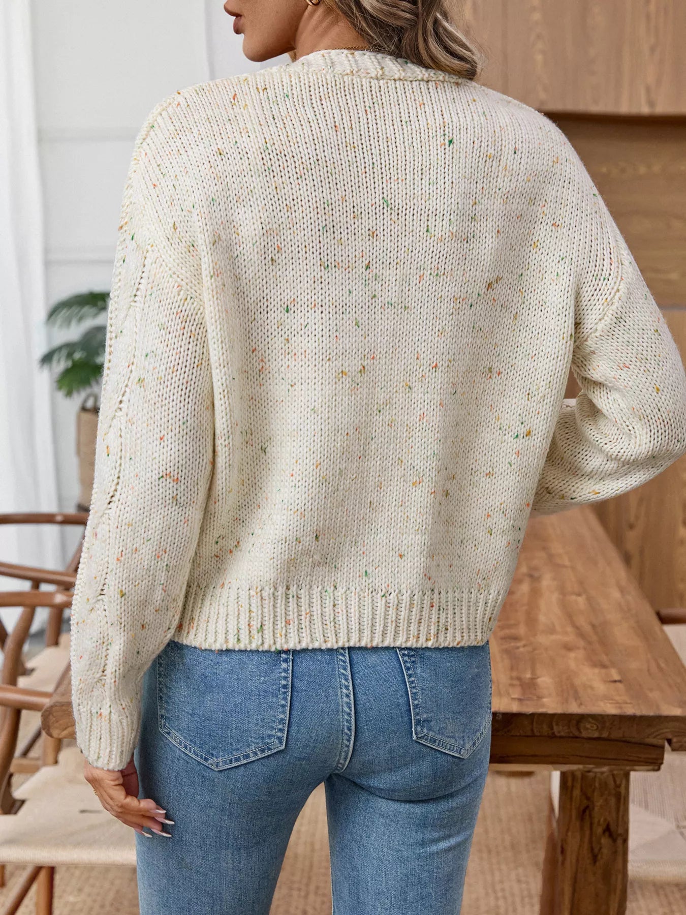 Beige cable knit cardigan, back view with textured knit and long sleeves