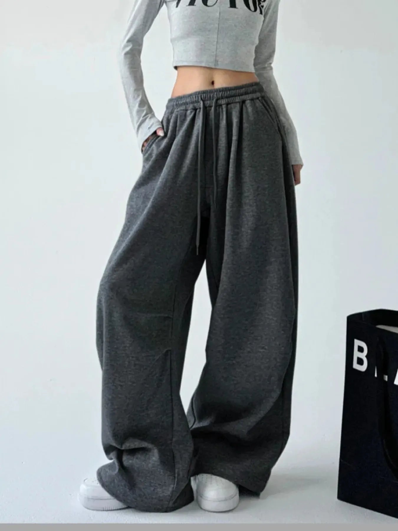 Dark gray oversized wide-leg drawstring pants with loose, roomy legs