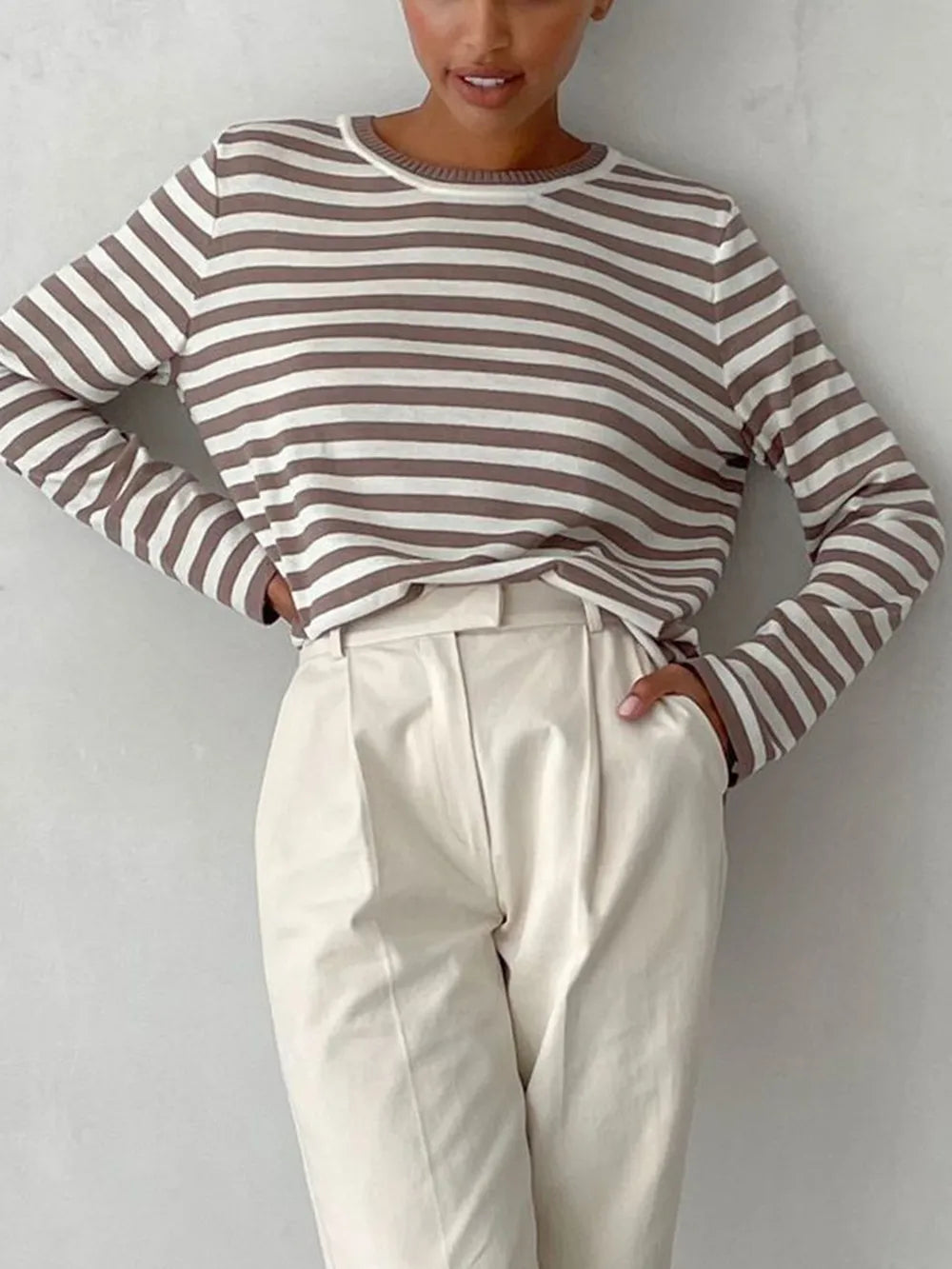 Striped long-sleeve sweater with round neck, mocha and white horizontal stripes.
