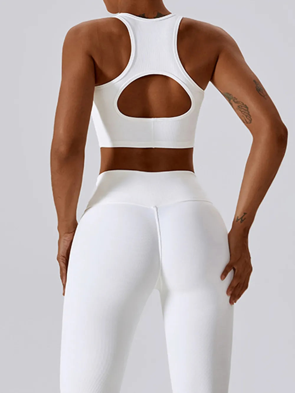 White racerback active crop tank with large oval cutout back
