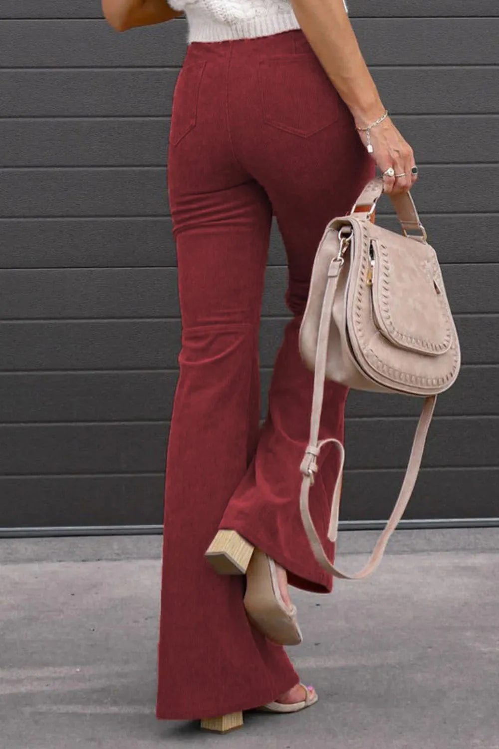 High-waist bootcut pants in deep burgundy with front button and side pockets